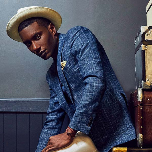 man wearing a hat and blue blazer