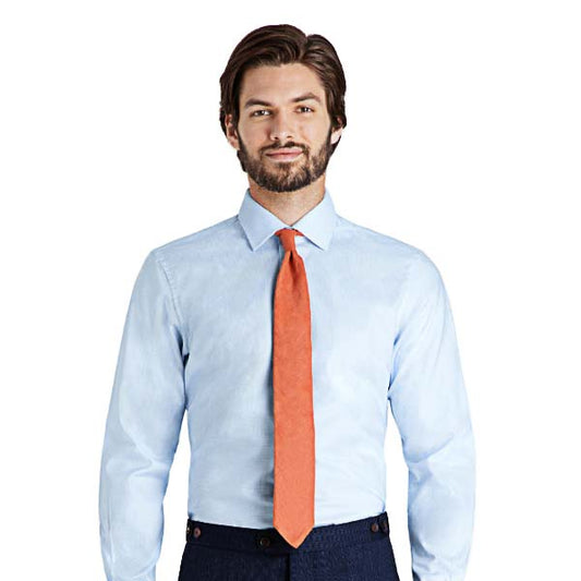 man wearing orange tie and fitted blue dress shirt