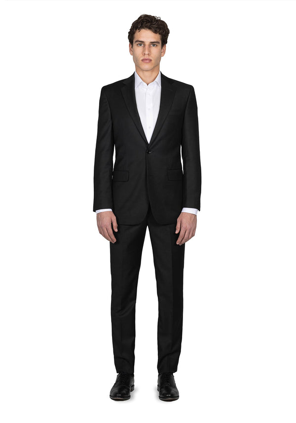 Model dressed in Black Lapel’s solid charcoal suit