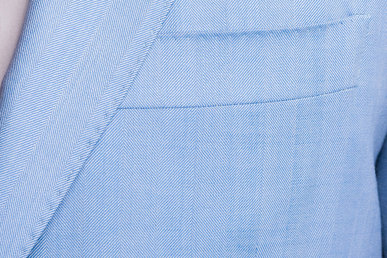 pick stitching on a blue herringbone jacket